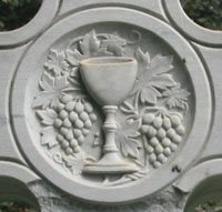 Cup, vine and grapes